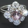 A striking pink tourmaline and diamond cluster ring, combining the captivating colour of a substantial tourmaline with the brilliance of diamonds. The 3-carat pink tourmaline provides a vivid focal point, beautifully complemented by 2.4 carats of brilliant-cut diamonds for an impressive and colourful statement.