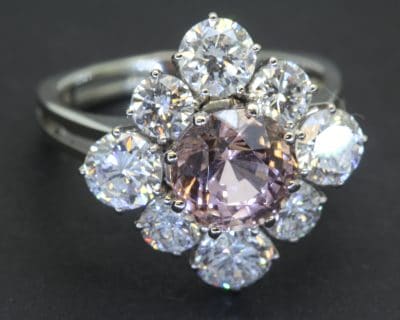 A striking pink tourmaline and diamond cluster ring, combining the captivating colour of a substantial tourmaline with the brilliance of diamonds. The 3-carat pink tourmaline provides a vivid focal point, beautifully complemented by 2.4 carats of brilliant-cut diamonds for an impressive and colourful statement.