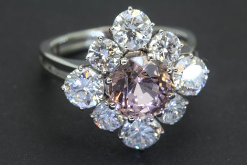 A striking pink tourmaline and diamond cluster ring, combining the captivating colour of a substantial tourmaline with the brilliance of diamonds. The 3-carat pink tourmaline provides a vivid focal point, beautifully complemented by 2.4 carats of brilliant-cut diamonds for an impressive and colourful statement.