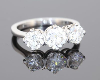 Elegant and timeless, this three-stone diamond ring combines the enduring beauty of diamonds with the refined sophistication of platinum. At its centre is a striking 0.91-carat diamond, graded E colour and SI1 clarity, complemented by two additional diamonds to create a beautifully balanced design with an impressive total diamond weight of 1.97 carats.