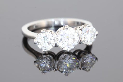 Elegant and timeless, this three-stone diamond ring combines the enduring beauty of diamonds with the refined sophistication of platinum. At its centre is a striking 0.91-carat diamond, graded E colour and SI1 clarity, complemented by two additional diamonds to create a beautifully balanced design with an impressive total diamond weight of 1.97 carats.