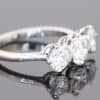 Elegant and timeless, this three-stone diamond ring combines the enduring beauty of diamonds with the refined sophistication of platinum. At its centre is a striking 0.91-carat diamond, graded E colour and SI1 clarity, complemented by two additional diamonds to create a beautifully balanced design with an impressive total diamond weight of 1.97 carats.