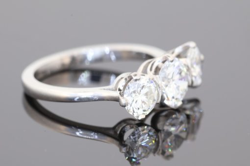 Elegant and timeless, this three-stone diamond ring combines the enduring beauty of diamonds with the refined sophistication of platinum. At its centre is a striking 0.91-carat diamond, graded E colour and SI1 clarity, complemented by two additional diamonds to create a beautifully balanced design with an impressive total diamond weight of 1.97 carats.