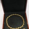 A striking 18-carat yellow-gold necklace by Manfred Seitner of Vienna, distinguished by its sculptural geometry and beautifully restrained use of texture. The necklace has a distinctly architectural quality, combining articulated cylindrical forms with subtle variations in angle to create a dynamic and highly contemporary silhouette. The accompanying matching ear clips complete the suite, echoing the necklace's geometric language in a beautifully cohesive design.