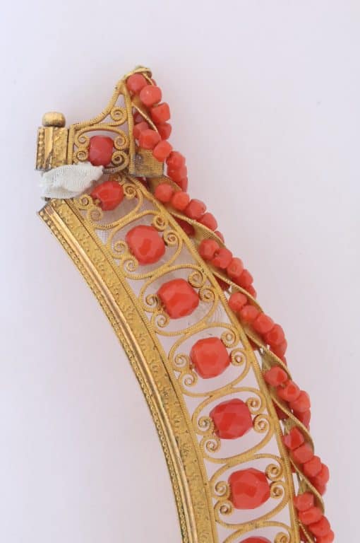 A remarkable antique parure of coral, garnet, cultured pearl, 18kt gold and gilded metal, associated with the Countess du Durat. An extraordinary and highly unusual suite comprising three tiaras, a necklace, a pair of ear pendants, a pair of ear clips and two bracelets. The parure is particularly evocative for its aristocratic association and the extraordinary breadth of the suite. The Comtesses de Durat belonged to a lineage whose history extended through one of the most turbulent periods of French history, navigating the upheavals of the French Revolution before re-establishing their position within aristocratic society during the Napoleonic era. The family also had a Caribbean branch connected with French colonial administration in territories including Grenada and Saint Martin, while members of the family in mainland France maintained important estates and family residences. Among the women associated with the lineage were Jeanne-Caroline de Patouillet de Deservillers and Marie Marguerite Henriette de Durat, figures remembered in regional records for their cultivation and erudition.