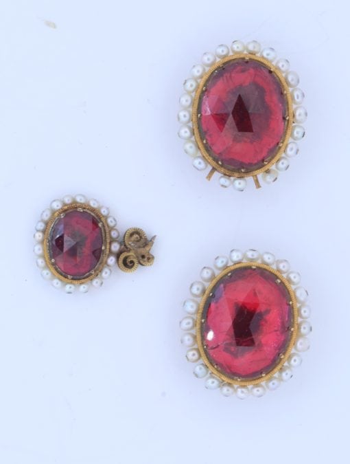 A remarkable antique parure of coral, garnet, cultured pearl, 18kt gold and gilded metal, associated with the Countess du Durat. An extraordinary and highly unusual suite comprising three tiaras, a necklace, a pair of ear pendants, a pair of ear clips and two bracelets. The parure is particularly evocative for its aristocratic association and the extraordinary breadth of the suite. The Comtesses de Durat belonged to a lineage whose history extended through one of the most turbulent periods of French history, navigating the upheavals of the French Revolution before re-establishing their position within aristocratic society during the Napoleonic era. The family also had a Caribbean branch connected with French colonial administration in territories including Grenada and Saint Martin, while members of the family in mainland France maintained important estates and family residences. Among the women associated with the lineage were Jeanne-Caroline de Patouillet de Deservillers and Marie Marguerite Henriette de Durat, figures remembered in regional records for their cultivation and erudition.
