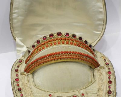 A remarkable antique parure of coral, garnet, cultured pearl, 18kt gold and gilded metal, associated with the Countess du Durat. An extraordinary and highly unusual suite comprising three tiaras, a necklace, a pair of ear pendants, a pair of ear clips and two bracelets. The parure is particularly evocative for its aristocratic association and the extraordinary breadth of the suite. The Comtesses de Durat belonged to a lineage whose history extended through one of the most turbulent periods of French history, navigating the upheavals of the French Revolution before re-establishing their position within aristocratic society during the Napoleonic era. The family also had a Caribbean branch connected with French colonial administration in territories including Grenada and Saint Martin, while members of the family in mainland France maintained important estates and family residences. Among the women associated with the lineage were Jeanne-Caroline de Patouillet de Deservillers and Marie Marguerite Henriette de Durat, figures remembered in regional records for their cultivation and erudition.