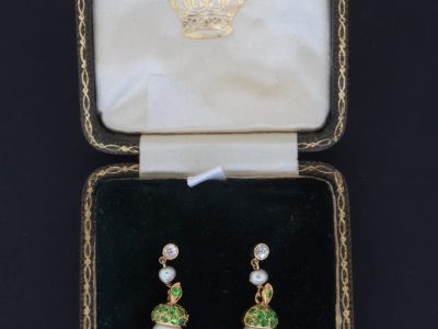 A superb pair of natural pearl and demantoid garnet drop earrings, presented in their original fitted case. The combination of natural pearls and vivid green demantoid garnets creates a particularly elegant and distinctive pairing, with the original case adding to their appeal and historical character.