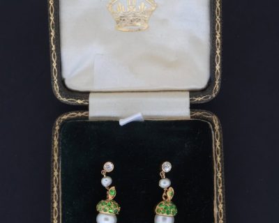 A superb pair of natural pearl and demantoid garnet drop earrings, presented in their original fitted case. The combination of natural pearls and vivid green demantoid garnets creates a particularly elegant and distinctive pairing, with the original case adding to their appeal and historical character.