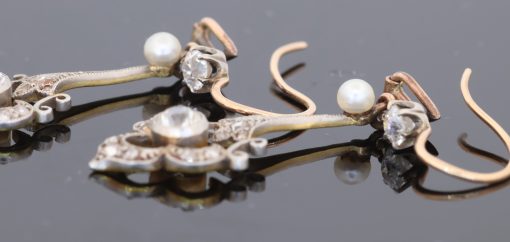 A beautiful pair of antique Belle Époque diamond and pearl drop earrings, dating to circa 1910. Elegant and refined, they capture the graceful femininity of the period, when delicate diamond jewellery and the soft lustre of pearls were particularly fashionable.