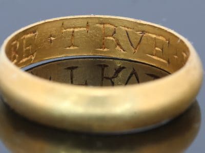 An extremely rare Tudor gold posy ring, engraved to the interior with the wonderfully intimate inscription “BE TRVE IN HART”, meaning “Be true in heart.” The ring was found by a metal detectorist in Shropshire in October 2024, adding a remarkable modern chapter to its long history. Posy rings were deeply personal jewels, traditionally engraved with short expressions of love, loyalty or devotion, and this inscription is particularly evocative in its simplicity. Examples bearing this distinctive Gothic-style lettering tend to date to around 1600, placing this ring at a fascinating point between the Tudor and early Stuart periods. Comparable examples can be found in the collections of both the British Museum and the Victoria and Albert Museum.