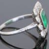 A superb Edwardian emerald and diamond ring, dating to circa 1905 and set in platinum. At its centre is a magnificent 1.5-carat step-cut emerald, distinguished by its exceptional colour and framed by a graceful surround of antique-cut diamonds. The combination of vivid emerald and the cool brilliance of platinum is quintessentially Edwardian, creating a jewel of considerable elegance and character.