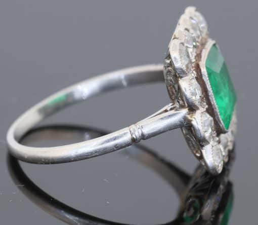 A superb Edwardian emerald and diamond ring, dating to circa 1905 and set in platinum. At its centre is a magnificent 1.5-carat step-cut emerald, distinguished by its exceptional colour and framed by a graceful surround of antique-cut diamonds. The combination of vivid emerald and the cool brilliance of platinum is quintessentially Edwardian, creating a jewel of considerable elegance and character.