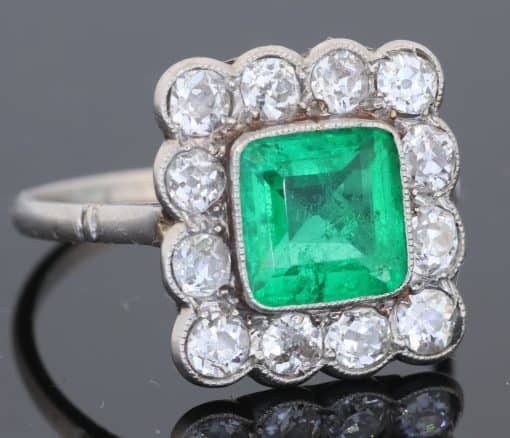 A superb Edwardian emerald and diamond ring, dating to circa 1905 and set in platinum. At its centre is a magnificent 1.5-carat step-cut emerald, distinguished by its exceptional colour and framed by a graceful surround of antique-cut diamonds. The combination of vivid emerald and the cool brilliance of platinum is quintessentially Edwardian, creating a jewel of considerable elegance and character.