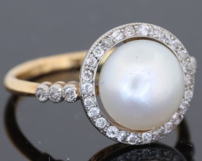 An extremely rare natural pearl and diamond cluster ring, made in Paris circa 1910. The ring centres on a beautiful natural pearl, accompanied by a Gem Lab certificate confirming its natural origin. The combination of natural pearl, diamonds and 18kt gold is characteristic of the refined French jewellery of the early 20th century, when natural pearls were among the most coveted gems in fine jewellery.