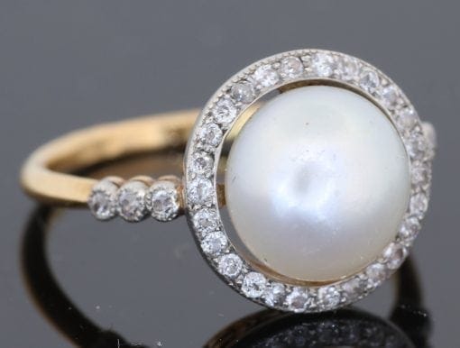 An extremely rare natural pearl and diamond cluster ring, made in Paris circa 1910. The ring centres on a beautiful natural pearl, accompanied by a Gem Lab certificate confirming its natural origin. The combination of natural pearl, diamonds and 18kt gold is characteristic of the refined French jewellery of the early 20th century, when natural pearls were among the most coveted gems in fine jewellery.