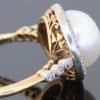 An extremely rare natural pearl and diamond cluster ring, made in Paris circa 1910. The ring centres on a beautiful natural pearl, accompanied by a Gem Lab certificate confirming its natural origin. The combination of natural pearl, diamonds and 18kt gold is characteristic of the refined French jewellery of the early 20th century, when natural pearls were among the most coveted gems in fine jewellery.