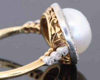 An extremely rare natural pearl and diamond cluster ring, made in Paris circa 1910. The ring centres on a beautiful natural pearl, accompanied by a Gem Lab certificate confirming its natural origin. The combination of natural pearl, diamonds and 18kt gold is characteristic of the refined French jewellery of the early 20th century, when natural pearls were among the most coveted gems in fine jewellery.