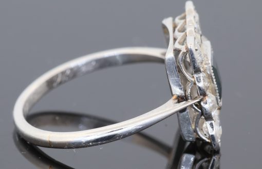 A charming antique sapphire and diamond cluster ring, dating to circa 1923, set in platinum and carrying a wonderfully personal inscription inside the shank: “FHB to Gwen 1923”. The dated dedication gives this elegant jewel a tangible connection to its original owners, transforming it from a beautiful piece of jewellery into a small piece of personal history. The inscription suggests that the ring was presented to Gwen in 1923, making it particularly evocative as a period gift.