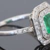 A beautiful Belle Époque emerald and diamond cluster ring, made in France circa 1910 and showcasing the period’s love of delicate platinum construction, fine diamonds and richly coloured gemstones. At its centre is a superb 1-carat Colombian emerald, surrounded by a double halo of diamonds that enhances the stone’s natural colour and gives the ring an elegant, balanced appearance.
