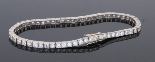 A superb antique Edwardian diamond line bracelet, dating to circa 1910 and characteristic of the elegant, refined jewellery of the period. Designed to allow the diamonds to take centre stage, the bracelet is set throughout with approximately four carats of Old European-cut diamonds, creating a continuous line of lively brilliance. The Edwardian period was renowned for its use of platinum and finely articulated diamond jewellery, with designs becoming increasingly light, elegant and focused on the natural beauty of the stones. This bracelet captures that aesthetic beautifully.