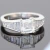 A superb diamond ring distinguished by the striking geometry of a rare carré-cut diamond. Celebrated for its clean lines and architectural elegance, the carré cut brings a distinctive character to this exceptional design, beautifully complemented by the precision and sparkle of its accompanying diamonds.