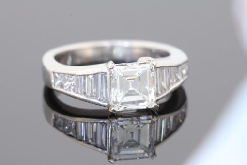 A superb diamond ring distinguished by the striking geometry of a rare carré-cut diamond. Celebrated for its clean lines and architectural elegance, the carré cut brings a distinctive character to this exceptional design, beautifully complemented by the precision and sparkle of its accompanying diamonds.