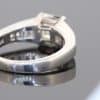 A superb diamond ring distinguished by the striking geometry of a rare carré-cut diamond. Celebrated for its clean lines and architectural elegance, the carré cut brings a distinctive character to this exceptional design, beautifully complemented by the precision and sparkle of its accompanying diamonds.