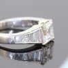 A superb diamond ring distinguished by the striking geometry of a rare carré-cut diamond. Celebrated for its clean lines and architectural elegance, the carré cut brings a distinctive character to this exceptional design, beautifully complemented by the precision and sparkle of its accompanying diamonds.