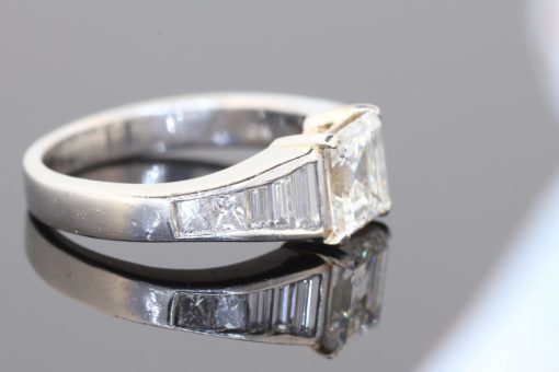 A superb diamond ring distinguished by the striking geometry of a rare carré-cut diamond. Celebrated for its clean lines and architectural elegance, the carré cut brings a distinctive character to this exceptional design, beautifully complemented by the precision and sparkle of its accompanying diamonds.