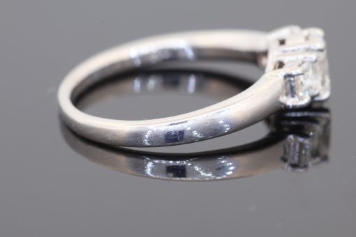 A timeless expression of elegance, this three-stone diamond ring brings together classic proportions and refined platinum craftsmanship. Its balanced design celebrates the enduring appeal of diamonds, making it a sophisticated choice for an engagement ring or a treasured addition to a fine jewellery collection.