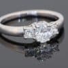 A timeless expression of elegance, this three-stone diamond ring brings together classic proportions and refined platinum craftsmanship. Its balanced design celebrates the enduring appeal of diamonds, making it a sophisticated choice for an engagement ring or a treasured addition to a fine jewellery collection.