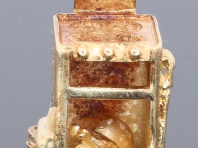 A wonderfully rare 9kt gold novelty charm in the form of a traditional cooker, complete with a charming surprise inside. The piece is a delightful example of the whimsical and imaginative approach taken to novelty jewellery, transforming an everyday household object into a miniature gold charm.
