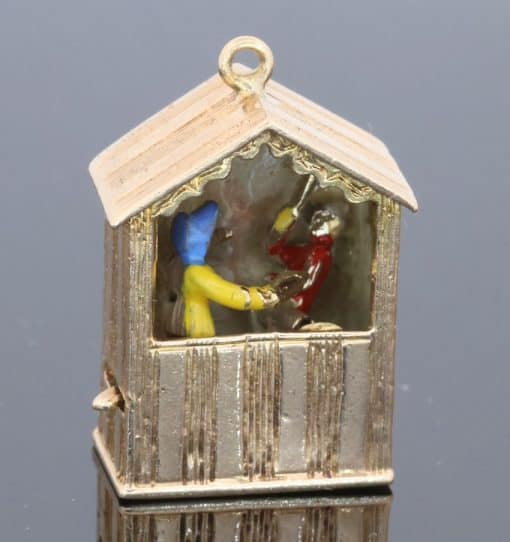 An extremely rare and wonderfully whimsical large gold charm depicting a Punch & Judy show, capturing the theatrical character and humour of one of Britain’s most enduring forms of popular entertainment. Punch & Judy performances have long been associated with seaside resorts, fairs and street entertainment, making this an especially charming subject for a piece of jewellery. The remarkable mechanical element makes the charm particularly unusual and collectible.