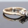 Elegant and distinctive, this three-stone twist ring combines the warm lustre of gold with a graceful, flowing design. The three-stone arrangement offers a timeless appeal, while the twisted form introduces a sense of movement and individuality.