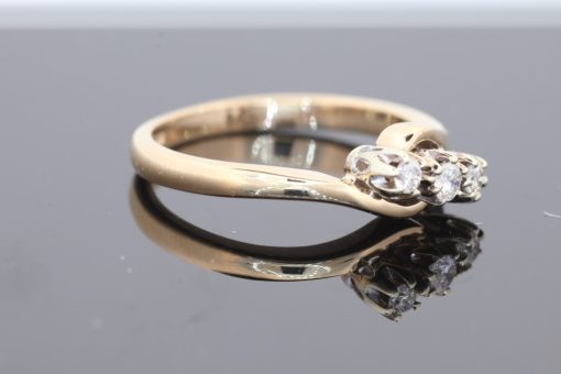 Elegant and distinctive, this three-stone twist ring combines the warm lustre of gold with a graceful, flowing design. The three-stone arrangement offers a timeless appeal, while the twisted form introduces a sense of movement and individuality.