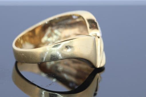 Distinctive and elegant, this wide diamond ring combines the warm lustre of gold with the brilliance of diamonds in an expressive, flowing design. Its unusual wave pattern gives the ring a sculptural quality, creating a piece that balances bold proportions with refined detailing.