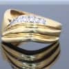 Distinctive and elegant, this wide diamond ring combines the warm lustre of gold with the brilliance of diamonds in an expressive, flowing design. Its unusual wave pattern gives the ring a sculptural quality, creating a piece that balances bold proportions with refined detailing.