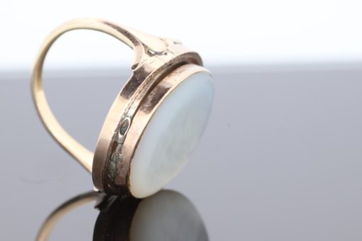 An exceptional Victorian locket ring dating to circa 1870, a fascinating example of the ingenuity and sentimentality that characterised nineteenth-century jewellery. During the Victorian era, personal jewellery often carried intimate meaning, with hidden compartments and keepsake designs allowing treasured photographs and mementoes to be kept close. This remarkable ring combines that romantic tradition with an unusual and ingenious mechanism.