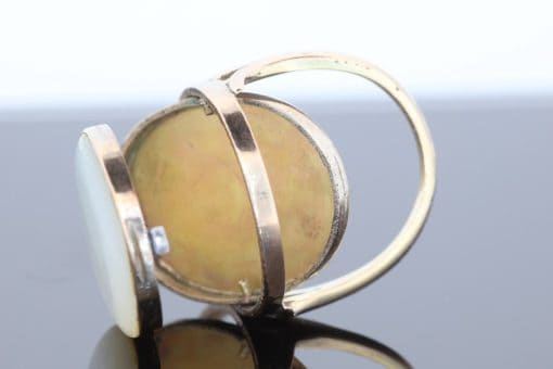 An exceptional Victorian locket ring dating to circa 1870, a fascinating example of the ingenuity and sentimentality that characterised nineteenth-century jewellery. During the Victorian era, personal jewellery often carried intimate meaning, with hidden compartments and keepsake designs allowing treasured photographs and mementoes to be kept close. This remarkable ring combines that romantic tradition with an unusual and ingenious mechanism.