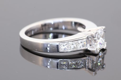Elegant and contemporary, this princess-cut diamond ring combines clean geometric lines with the timeless appeal of fine diamond jewellery. Set in 18kt white gold, it centres on a striking 1-carat princess-cut diamond, graded D colour and SI2 clarity, accompanied by a GIA certificate.